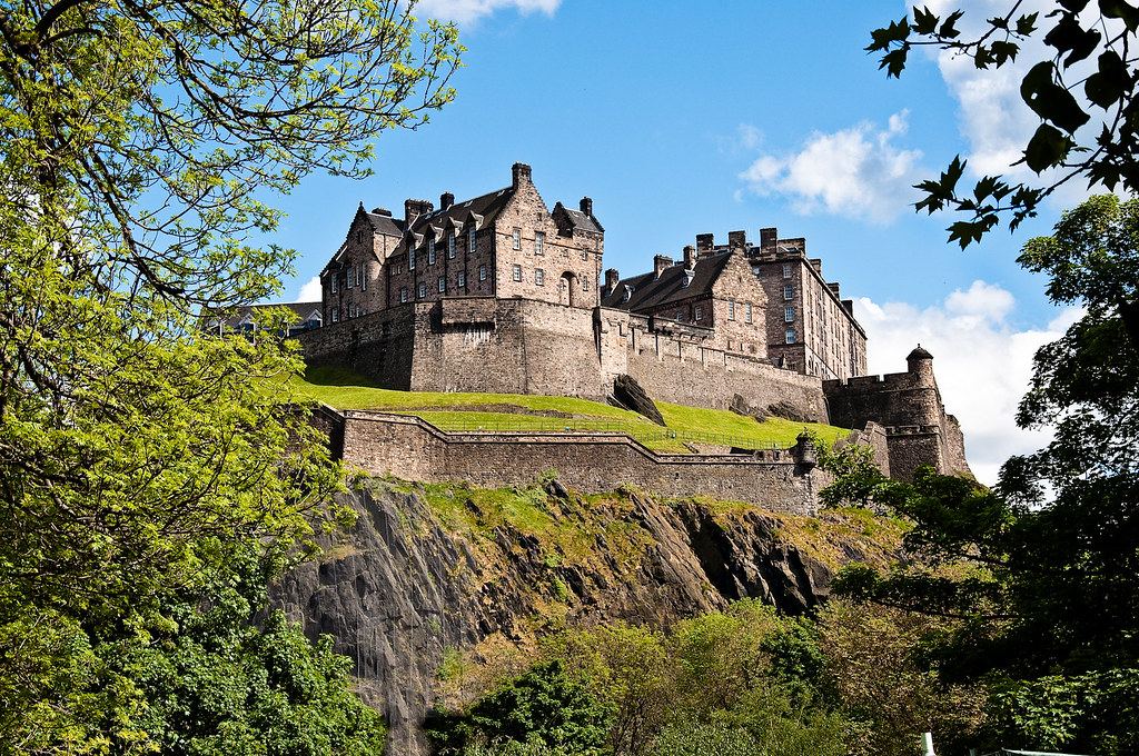 Edinburgh Castle glowing at golden hour above Princes Street Gardens